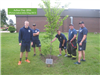 Sedgwick County Fire stands near newly planted tree at fire station #37 for Arbor Day 2016.
