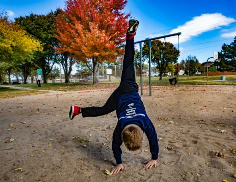 Child doing cartwheel on playground