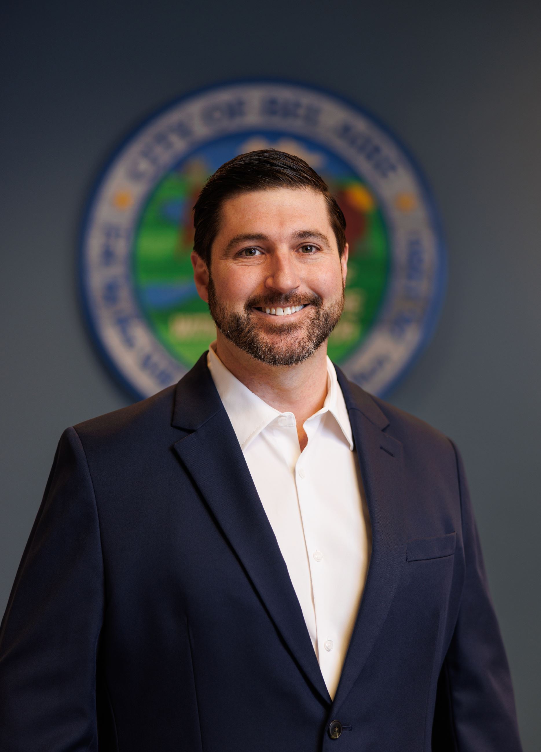 Mike Proctor Bel Aire City Council Member in a white shirt and black suit