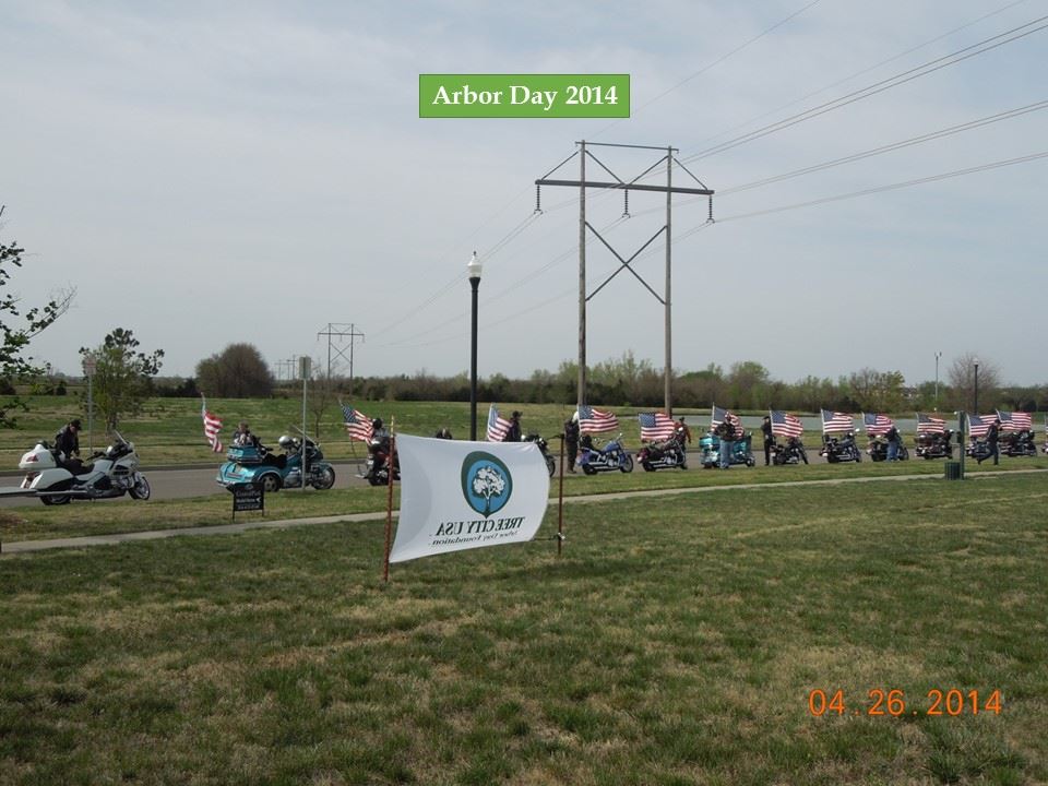 Motorcycles with American flags line the street at the 2014 Arbor Day ceremony.