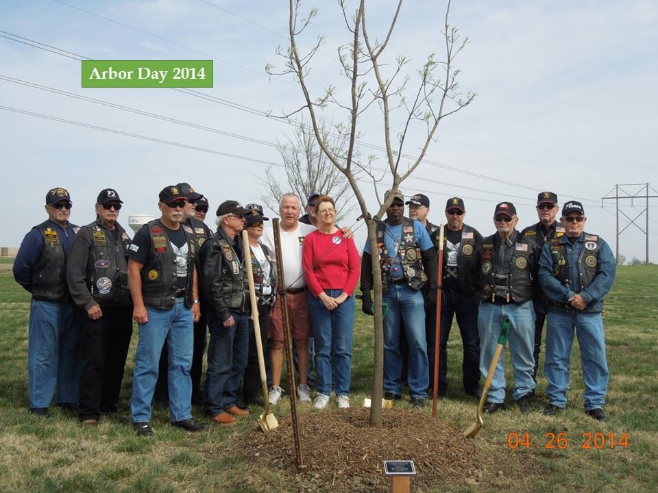 Friends and family gather near the tree planted for Arbor Day 2014 in honor of Sgt. Alex Funcheon.
